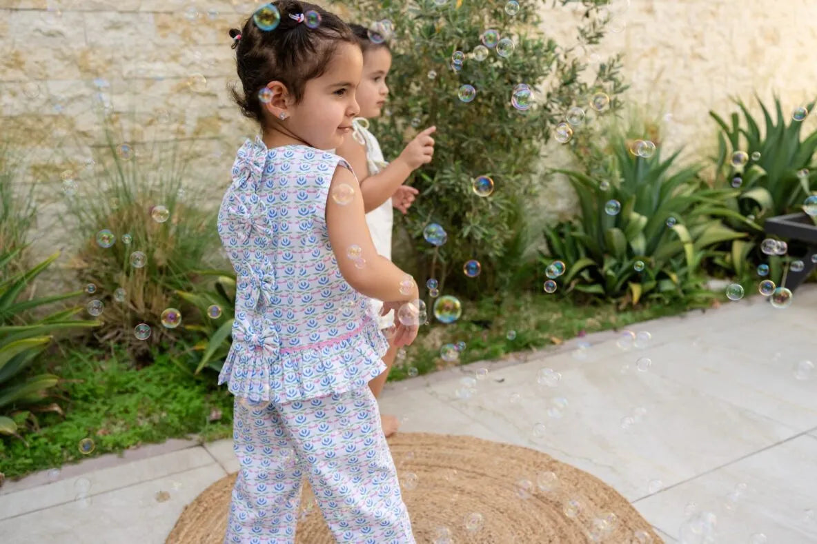 Child in blue patterned outfit